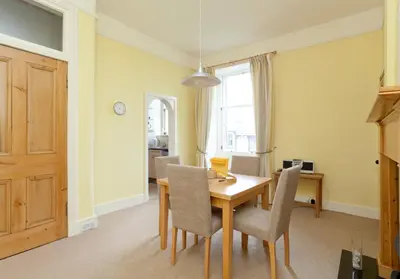 a dining room with a wooden table and chairs at Mardale Crescent - 380 in Edinburgh