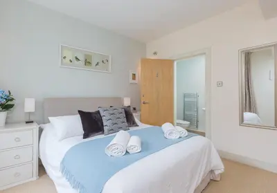 a bedroom with a bed with two towels on it at Thistle Street - 401 in Edinburgh