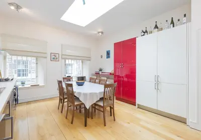 a kitchen with a table and chairs and a red refrigerator at Thistle Street - 401 in Edinburgh