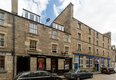 a large brick building with cars parked in front of it at Thistle Street - 401 in Edinburgh