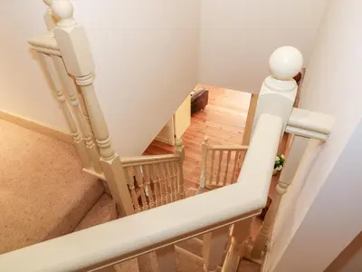 an overhead view of a staircase with white railings at The Roundhouse in Auchterarder