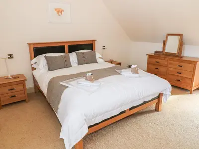 a bedroom with a bed with two towels on it at The Roundhouse in Auchterarder