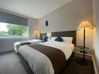 a hotel room with two beds and a window at No6 West Coates in Edinburgh