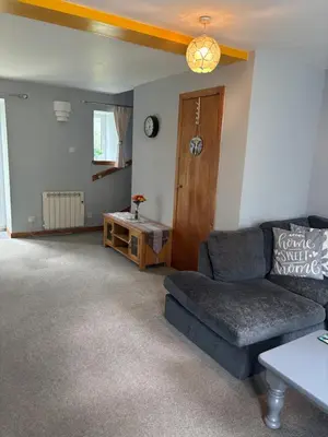 a living room with a couch and a table at Barfad Self Catering Holiday Cottages in Tarbert
