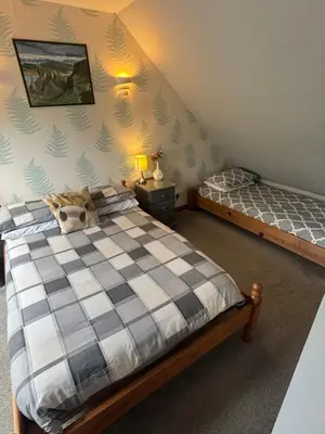 a bedroom with two beds in a attic at Barfad Self Catering Holiday Cottages in Tarbert