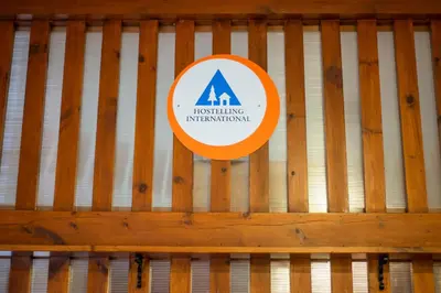 a sign on a wooden fence at Crianlarich Youth Hostel in Crianlarich