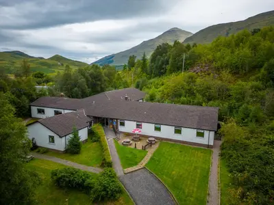 an aerial view of a house in the mountains at Crianlarich Youth Hostel in Crianlarich