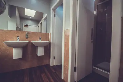 a bathroom with two sinks and a mirror at Boreland Loch Tay in Aberfeldy