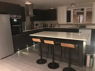 a kitchen with a island in the middle at The Shack & Pods at Inchree in Corran