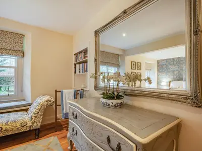 a room with a large mirror and a table at Barjols Cottage - Uk30096 in Wiston