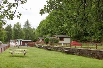 a picnic table in the grass in a park at Trekker Hut in Tyndrum