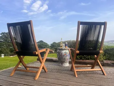 two chairs sitting on a deck with a vase at Stoneymollan over Loch Lomond in Balloch