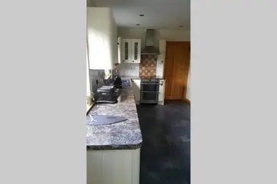 a kitchen with a counter and a stove top oven at The Curling Pond, Dalmally Road, Inveraray in Inveraray