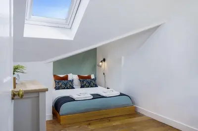 a bedroom with a bed in a white room at The Stirling Townhouse in Stirling
