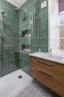 a green tiled bathroom with a shower and a sink at The Stirling Townhouse in Stirling