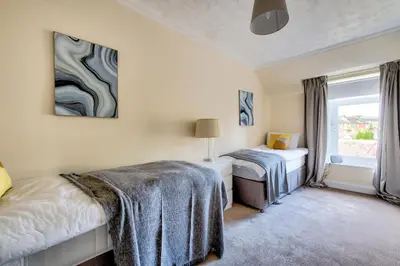 a bedroom with two beds and a window at Oaktree Appartment Moffat in Moffat