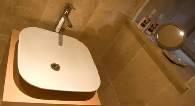 a white sink in a bathroom with a mirror at Kingsview Apartment in Stirling
