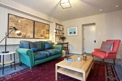 a living room with a couch and a table at Ross Lodge in Comrie
