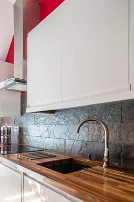 a kitchen with a sink and a white hood at Castle Vista, Grassmarket Apartment in Edinburgh