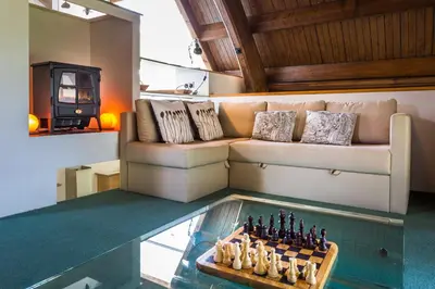 a living room with a chess board and a couch at Eastkirk in Corrie