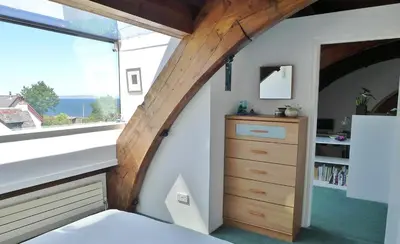 a bedroom with a large window and a dresser at Eastkirk in Corrie