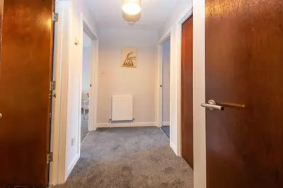a hallway with a door leading to a room at PREMIER - Wishaw En-Suite Apartment in Wishaw