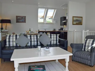 a living room with couches and a coffee table at The Bothy in Stron-fearnan