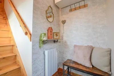 a living room with a couch and a stairs at Rowan Tree Apartment - Modern Apartment, Free Parking & Views in Oban