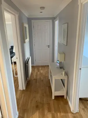 a room with a white desk and a white door at Flat One, 212 Eaglesham Road, East Kilbride, Glasgow in Glasgow