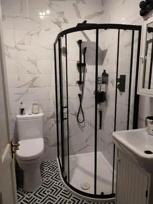 a bathroom with a shower and a toilet and a sink at Beautiful self contained apartment with garden in Glasgow