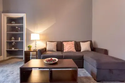 a living room with a couch and a table at Stunning 2-Bed Apartment in Central Edinburgh in Edinburgh