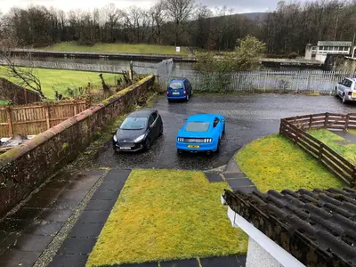 a group of cars parked in a parking lot at Levenview Holiday Apartment Loch Lom in Balloch