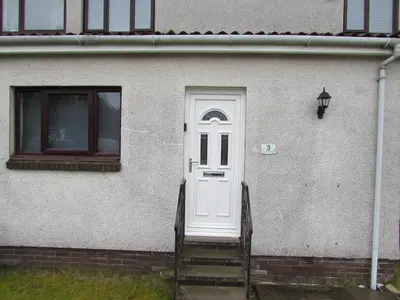 a white door on a house with a staircase at Levenview Holiday Apartment Loch Lom in Balloch