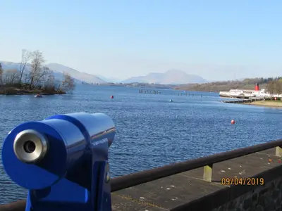 a blue camera on a railing near a body of water at Levenview Holiday Apartment Loch Lom in Balloch