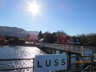 a sign on a bridge over a river at Levenview Holiday Apartment Loch Lom in Balloch
