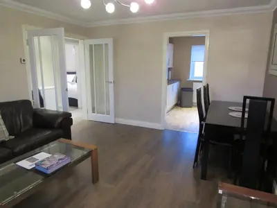 a living room with a couch and a table at Levenview Holiday Apartment Loch Lom in Balloch