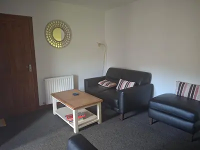 a living room with a couch and a table at Rockfoot B&B in Fintry