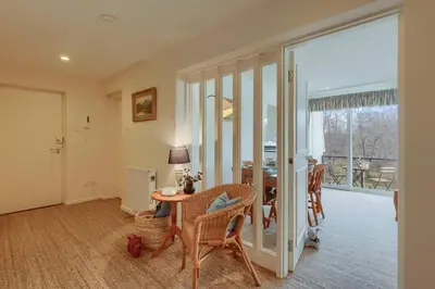 a living room with a table and chairs and a dining room at 45 Guthrie Court, Fantastic top floor apartment next to Gleneagles in Auchterarder