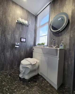a bathroom with a toilet and a sink and a mirror at Stay - Gilmore Guesthouse in Edinburgh