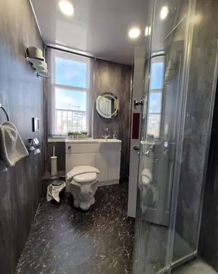 a bathroom with a toilet and a shower and a sink at Stay - Gilmore Guesthouse in Edinburgh