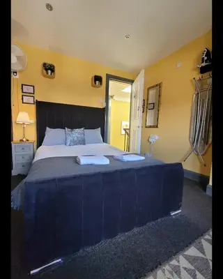a bedroom with a large bed with two towels on it at Stay - Gilmore Guesthouse in Edinburgh