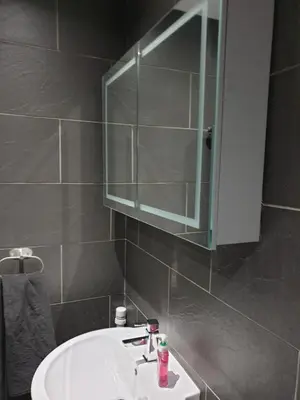 a bathroom with a sink and a mirror at Frederick Douglass - Rooms In The City in Edinburgh