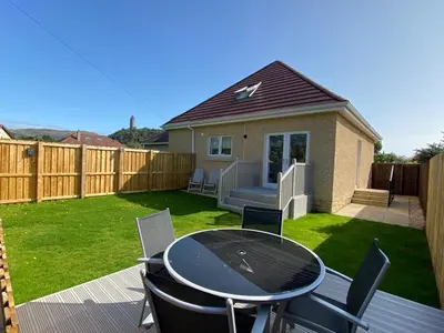 a patio with a table and chairs in a yard at Leworin in Stirling