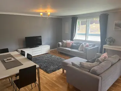 a living room with a couch and a table at Flat Two, 212 Eaglesham Road, East Kilbride, Glasgow in Glasgow