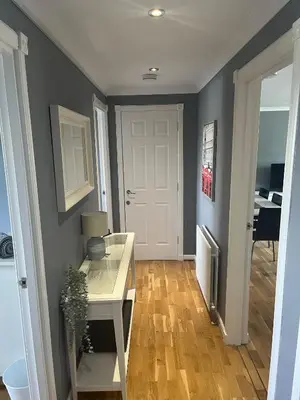 a room with a white desk and a white door at Flat Two, 212 Eaglesham Road, East Kilbride, Glasgow in Glasgow