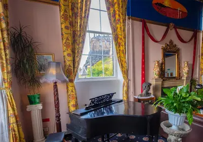 a room with a piano and a window at Castle Rock Hostel - Adults Only in Edinburgh