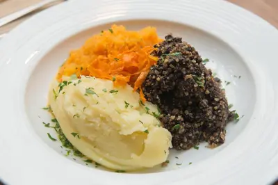 a plate of food with mashed potatoes and carrots at Babbity Bowsters in Glasgow