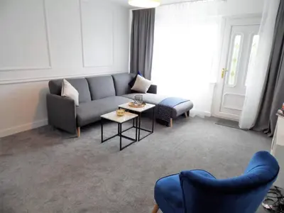 a living room with a couch and a table at Black Cart House in Johnstone