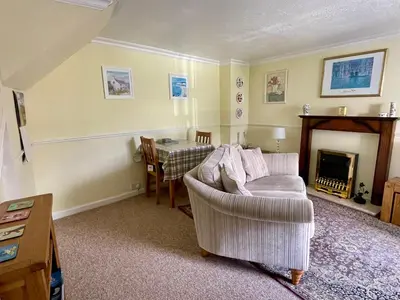 a living room with a couch and a table at TwoStones Self Catering Cottage in Arrochar