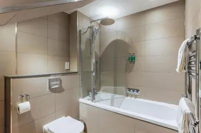 a bathroom with a tub and a toilet at Dragon Suites - Edinburgh City Centre 2 Bed Apartment in Edinburgh